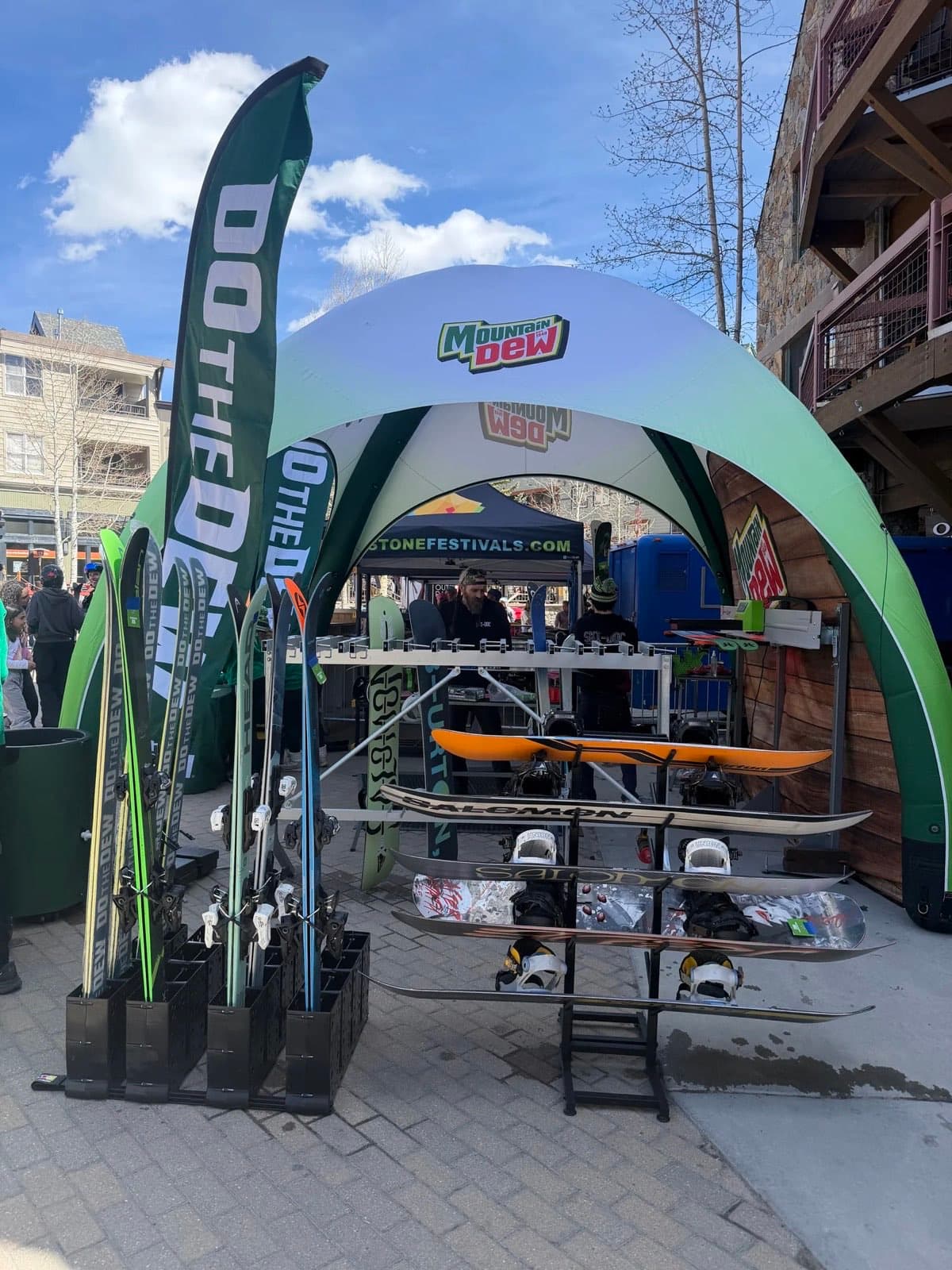Ski and snowboard racks at a branded Slope Ready event tent