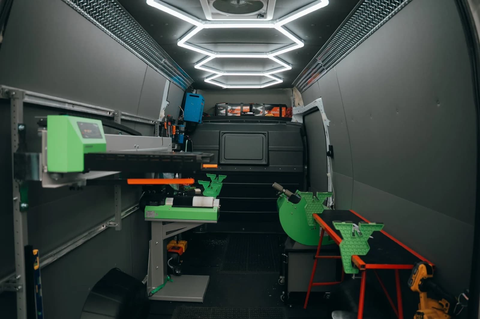 Inside the mobile ski shop van with pro tuning benches and equipment